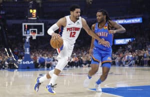 Apr 2, 2025; Oklahoma City, Oklahoma, USA; Detroit Pistons forward Tobias Harris (12) drives around Oklahoma City Thunder guard Cason Wallace (22) during the second quarter at Paycom Center. Mandatory Credit: Alonzo Adams-Imagn Images